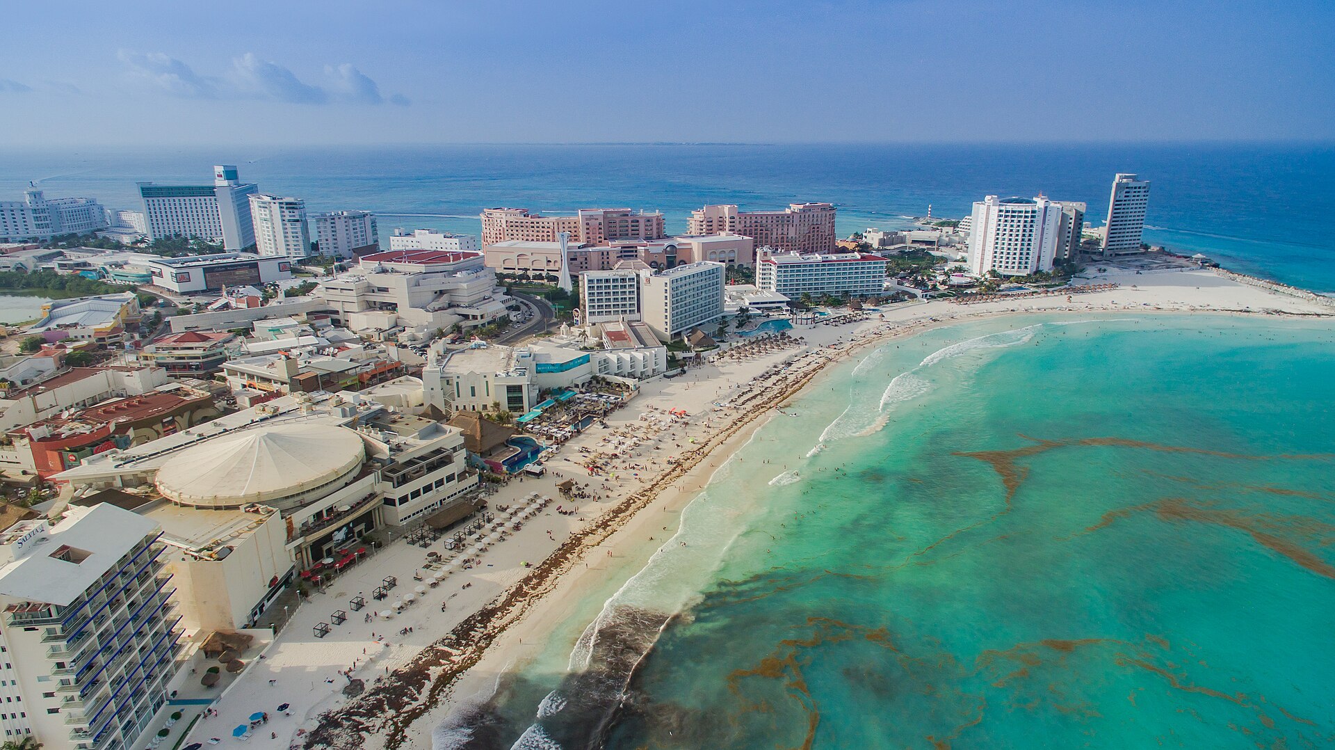 Aerial view of Cancún's Hotel Zone with hotels along a white-sand beach and turquoise sea