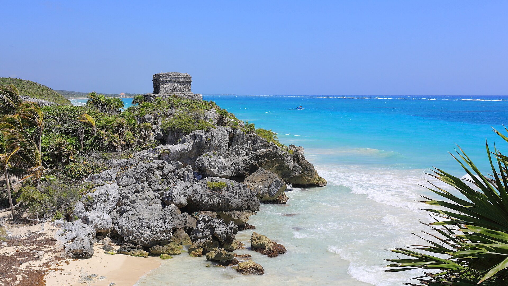The Temple of the God of the Winds on a rocky point above turquoise water at Tulum
